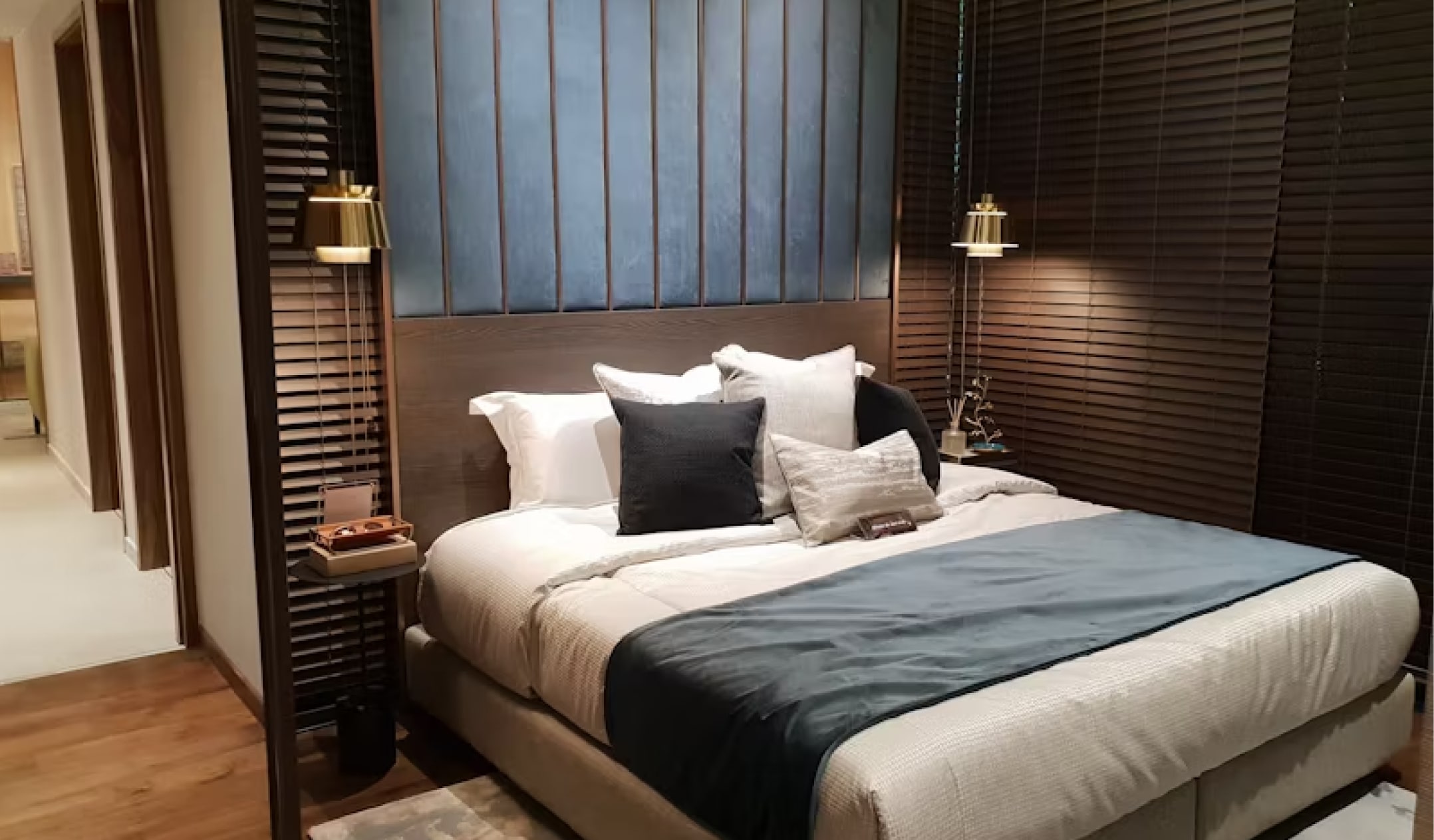 sleek bedroom with a ton of pillows on the bed